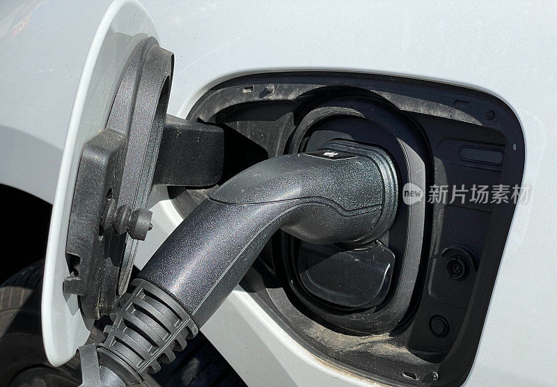 EV connector plug charging an electric car